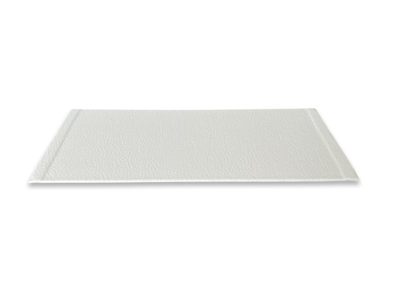 May include: A white rectangular tray with a textured surface. The tray has a slightly raised edge around the perimeter.