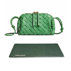 May include: A green woven crossbody bag with a matching green leather card holder. The bag has a woven design and a long strap. The card holder is rectangular and has the text "M BOUTIQUE" printed on it.