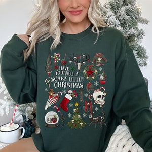 May include: A dark green sweatshirt with a festive Christmas design featuring skulls, candy canes, and the text "Have Yourself a Scary Little Christmas".