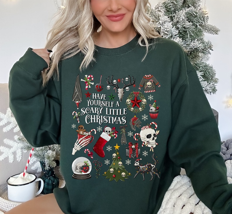 May include: A dark green sweatshirt with a festive Christmas design featuring skulls, candy canes, and the text "Have Yourself a Scary Little Christmas".