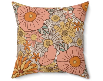 May include: A square cushion with a retro floral pattern. The cushion features a variety of flowers in shades of pink, orange, yellow, and green on a cream background.