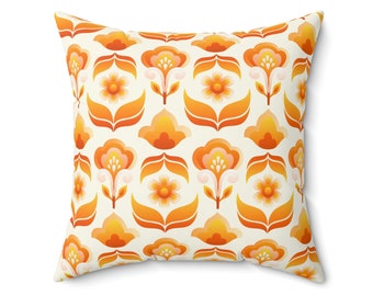 May include: A throw pillow featuring a retro floral design in shades of orange and yellow on a white background.