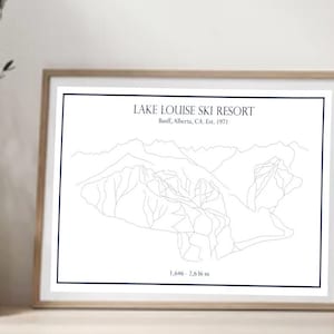 May include: A black and white line art print of the Lake Louise Ski Resort in Banff, Alberta, Canada. The print includes the resort's name, location, and establishment date, "Est. 1921". The print also includes the elevation of the resort, "1,686 - 2,616 m".