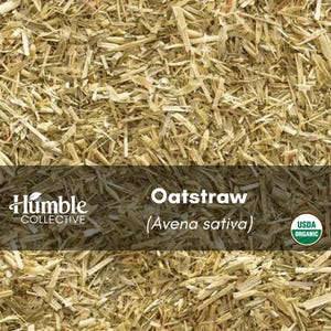 May include: A collection of dried, light tan oatstraw pieces, Avena sativa, with a label reading Humble Collective, Oatstraw (Avena sativa), and a circular USDA Organic seal. The texture is fibrous, consisting of chopped, pale yellow stalks.