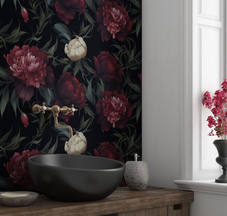 May include: Black and white floral wallpaper with large red and white peonies. A black oval sink with a gold faucet is in the foreground.