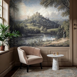 Cozy living space adorned with castle peel and stick wallpaper, presenting a pastoral scene with rolling hills and verdant foliage.