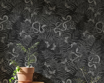 May include: Black and white wallpaper with a repeating pattern of snakes and butterflies. The wallpaper is shown on a wall with a small potted plant and a wooden stool in front of it.
