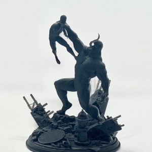 May include: A black and white 3D printed figurine of a large, muscular figure holding a smaller figure in its hand. The larger figure has horns and a menacing expression. The smaller figure is in a fighting pose. The figurine is set on a base with a destroyed cityscape.