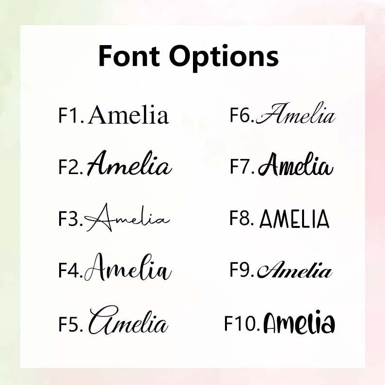 May include: A white chart titled Font Options displaying ten distinct black typeface styles labeled F1 through F10. Each option features the name Amelia in a different font, ranging from serif and sans-serif to various cursive and script styles.