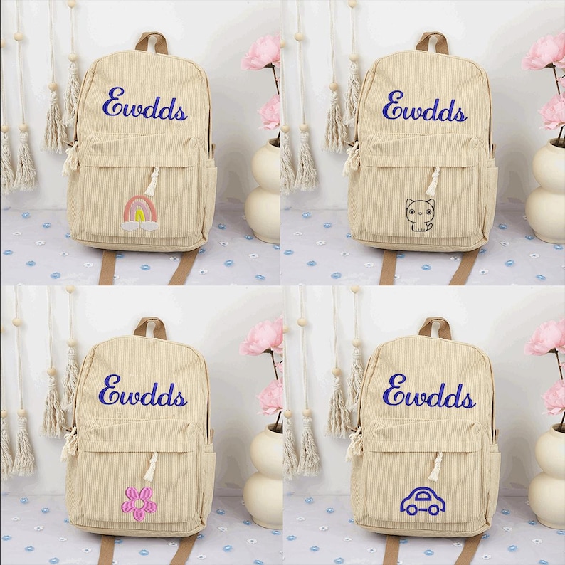 May include: Four beige corduroy backpacks with the word "Ewdds" embroidered in purple on the front. Each backpack has a different embroidered patch: a rainbow, a cat, a flower, and a car.