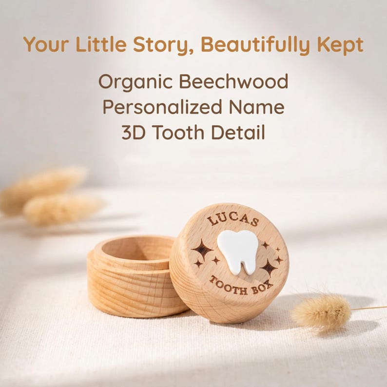 May include: A round, light-coloured wooden tooth box with a removable lid. The lid features the engraved text 'LUCAS' and 'TOOTH BOX' with star accents and a raised, white 3D tooth icon in the centre. The box is open, showing a hollow interior.