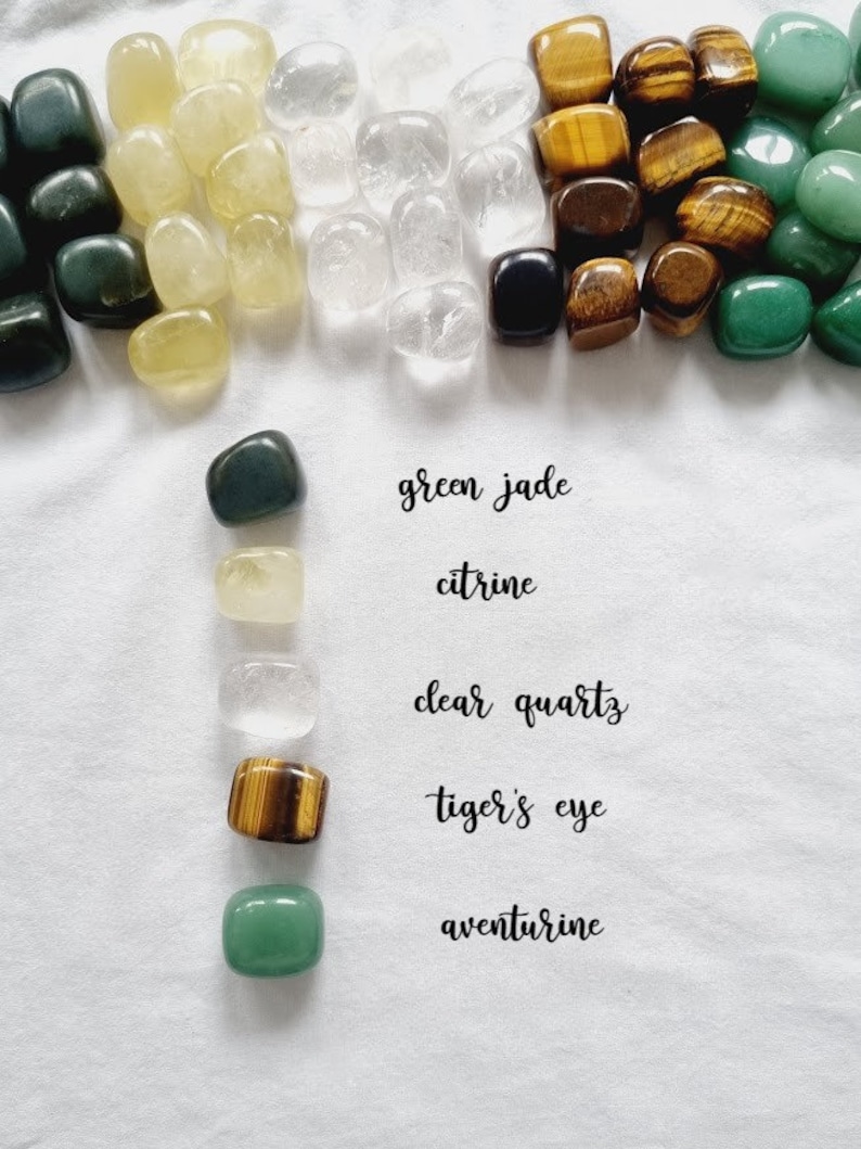 May include: Assortment of tumbled stones, including green jade, citrine, clear quartz, tiger's eye, and aventurine.