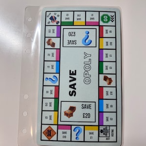 May include: A blue and white game board with the word "OPOLY" printed on it. The board has spaces for players to land on, including spaces that say "SAVE £1", "SAVE £10", "SAVE £20", and "SAVE £30". There is also a space that says "GO" and a space that says "JUST VISITING".