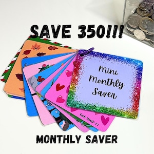 May include: A collection of mini monthly saver cards in various colours, including pink, blue, and orange. The cards are decorated with hearts, leaves, and cartoon characters. Text on the cards reads "Mini Monthly Saver" and "Monthly Saver", with "SAVE 350!!!" above.