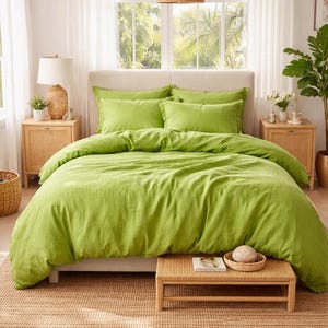 May include: A bright green bed set with a duvet cover and pillowcases. The bedding is on a bed with a neutral-colored headboard. The room has a natural, airy aesthetic with woven bedside tables and a woven pendant light.