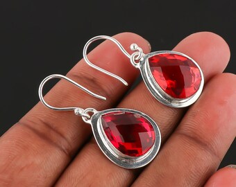 Peut inclure: Une paire de boucles d'oreilles pendantes en argent avec des pierres précieuses rouges en forme de goutte.