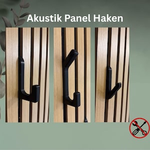 May include: Three wooden wall panels with black hooks. The panels have vertical wood grain and are mounted with black hooks. The text "Akustik Panel Haken" is at the top of the image. A no tools icon is in the bottom right corner.