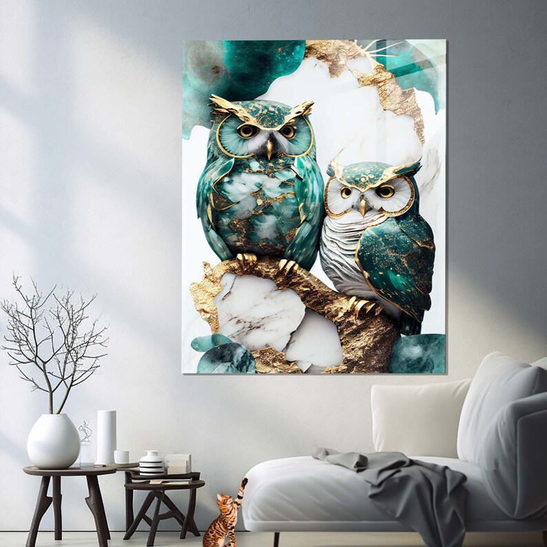 May include: Two green owls with gold accents perched on a branch with a marble and gold background.