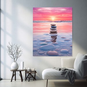 Puede incluir: Una pila de piedras lisas, grises y blancas, equilibradas una encima de la otra en el medio de una masa de agua poco profunda. El agua es de color azul claro y el fondo es un cielo de puesta de sol rosa y naranja.