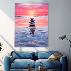 Puede incluir: Una pila de piedras lisas grises y blancas equilibradas una encima de la otra en aguas poco profundas al atardecer. El agua es de color rosa claro y el cielo es de un rosa y naranja vibrantes.