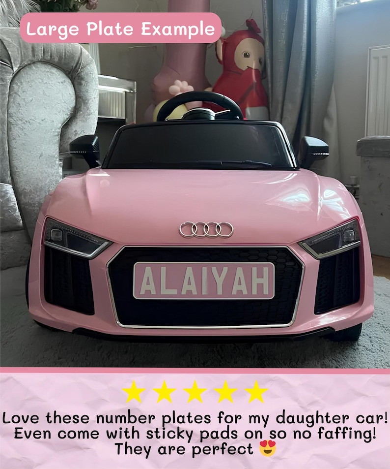 May include: A pink toy car with a black interior and the name "ALAIYAH" on a license plate. The car has the Audi logo on the front. The text "Large Plate Example" is at the top of the image.