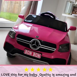 May include: A bright pink toy car with a black windshield and a silver emblem. The car has a license plate that reads "BON BON". The image also includes the text "Small Plate Example".