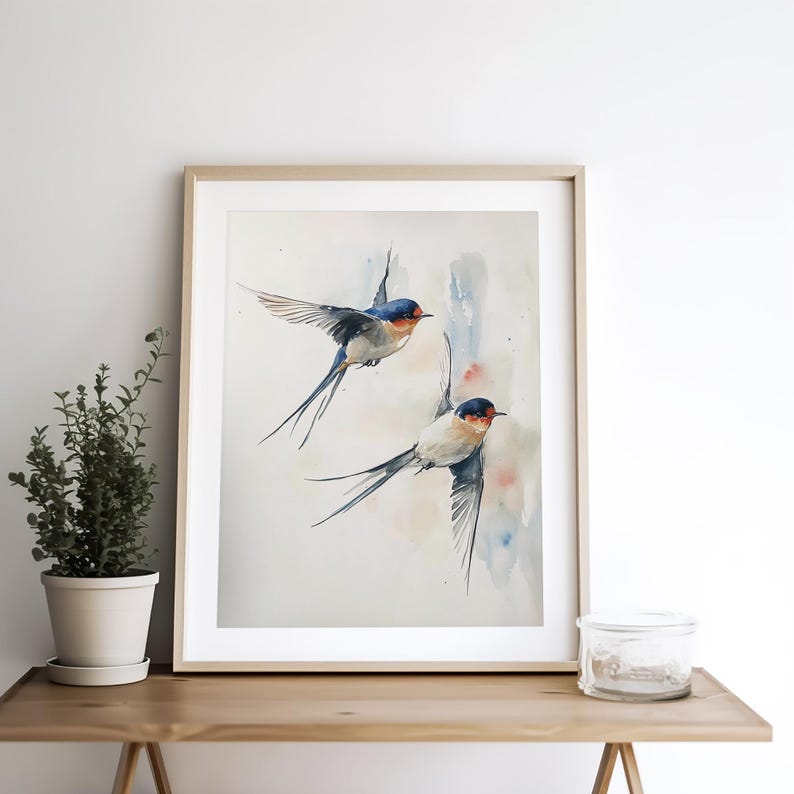 May include: Watercolor painting of two blue and white swallows in flight against a light blue and pink background.