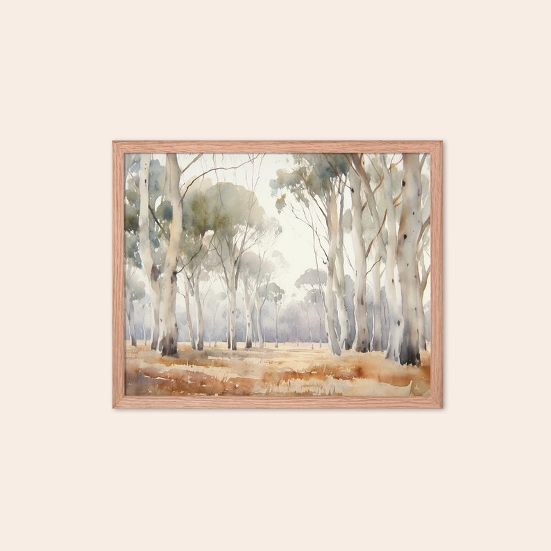May include: A watercolour painting depicting a forest scene with tall, slender trees featuring white bark. The trees are arranged in a line, creating a sense of depth and perspective. The background is a soft, hazy blue, suggesting a distant horizon. The painting is framed in a light wood frame.