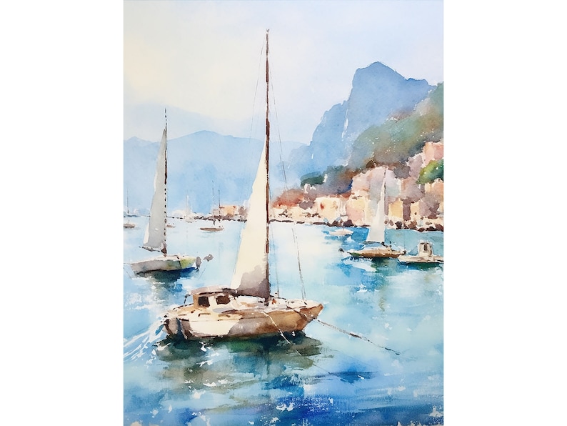 May include: Watercolour painting of a sailboat with white sails in a harbour with other sailboats and a town in the background.