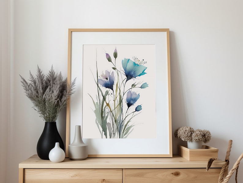 May include: A framed watercolor painting of blue and purple flowers with green stems and leaves on a white background.