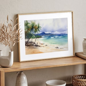 Peut inclure: Une peinture &agrave; l'aquarelle encadr&eacute;e repr&eacute;sentant une sc&egrave;ne de plage tropicale avec des palmiers, de l'eau bleue et un rivage sablonneux.