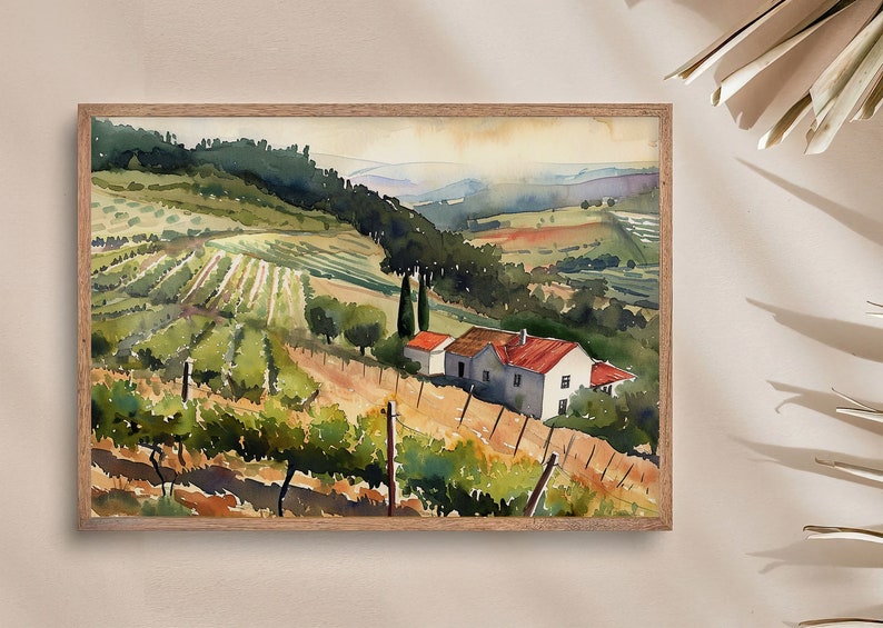 May include: Watercolor painting of a vineyard landscape with rolling hills, a farmhouse with a red roof, and rows of grapevines. The artwork is framed in a light brown wooden frame, showcasing a serene countryside scene.