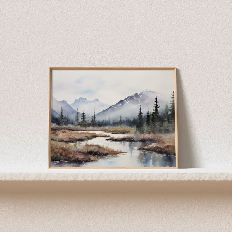 May include: Watercolor painting of a mountain landscape with a river flowing through it. The mountains are in the background and are painted in shades of blue and gray. The river is in the foreground and is painted in shades of blue and green. There are trees on both sides of the river.