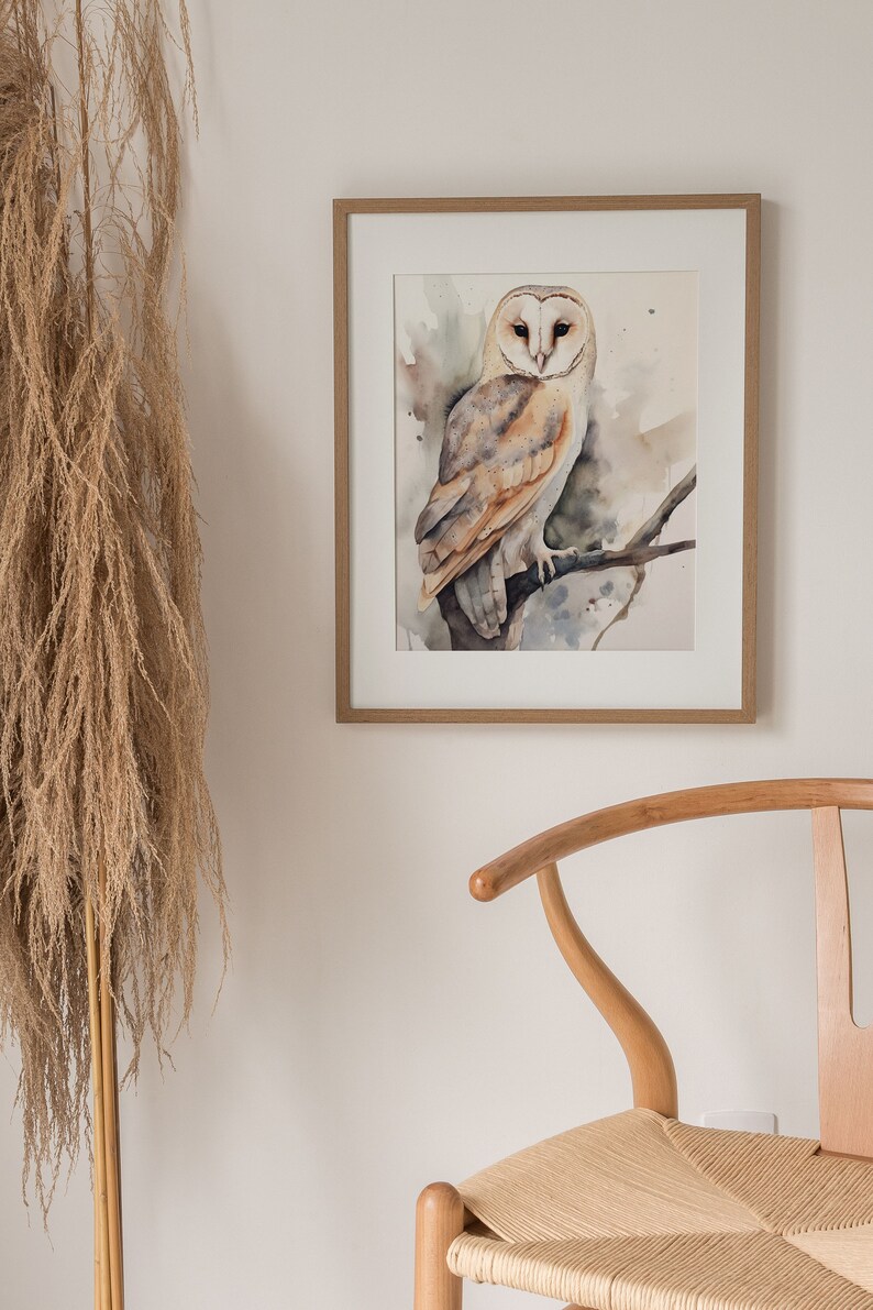 May include: A watercolor painting of a barn owl perched on a branch. The owl is white with brown markings and has large, yellow eyes. The background is a soft, watercolor wash of greens and browns.