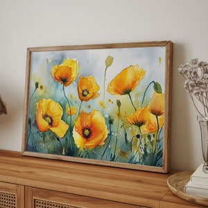 May include: Watercolor painting of yellow poppies on a white background. The flowers are in various stages of bloom and are arranged in a loose, flowing pattern. The painting is framed in a wooden frame.
