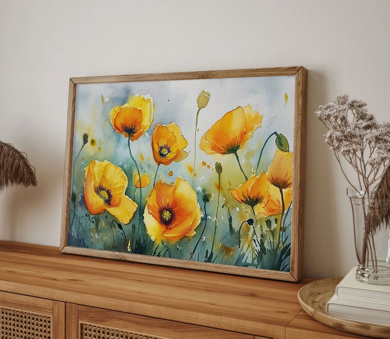May include: Watercolor painting of yellow poppies on a white background. The flowers are in various stages of bloom and are arranged in a loose, flowing pattern. The painting is framed in a wooden frame.