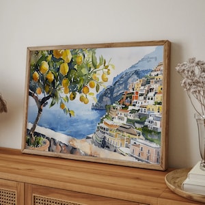 May include: Watercolor painting of a lemon tree with yellow lemons and green leaves in front of a colorful cityscape on a cliff overlooking a blue ocean.