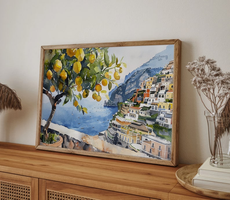 May include: Watercolor painting of a lemon tree with yellow lemons and green leaves in front of a colorful cityscape on a cliff overlooking a blue ocean.