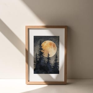 May include: Watercolor painting of a nighttime forest scene with a large, glowing moon. Silhouetted pine trees are in the foreground. The artwork is framed in a light brown wooden frame.