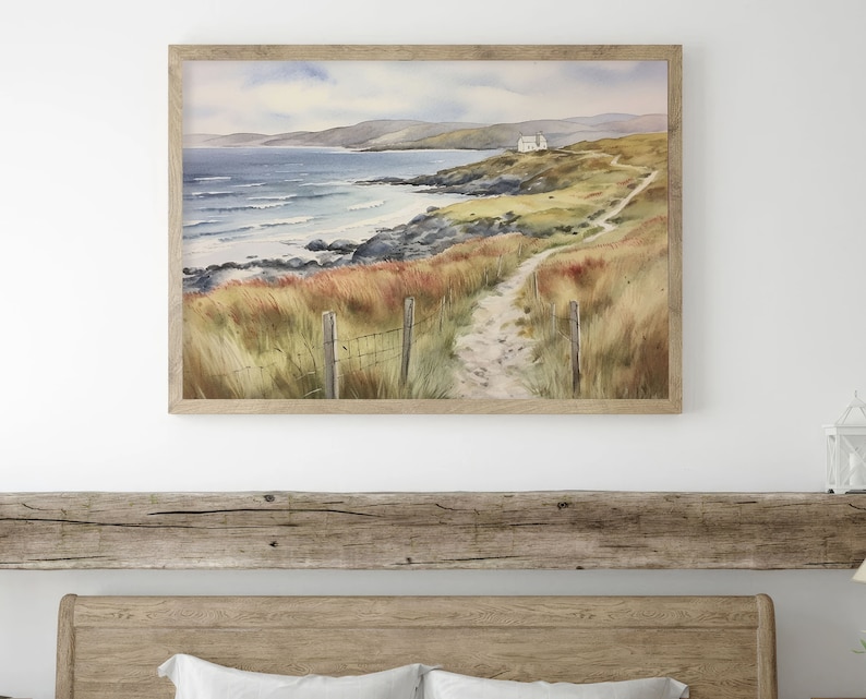 May include: A watercolour painting depicting a coastal scene with a white house perched on a hill overlooking a sandy beach and the ocean. A winding path leads to the house, with a wooden fence and green grass lining the way.