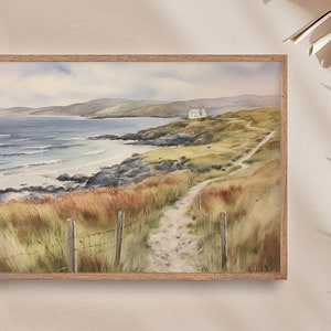 May include: A watercolour painting depicting a coastal scene with a white house perched on a hill overlooking a sandy beach and the ocean. A winding path leads to the house, surrounded by green grass and brown scrub.