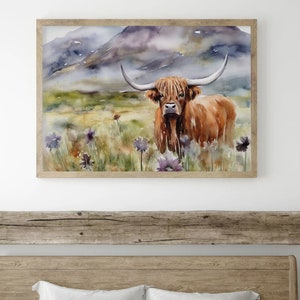 May include: Watercolor painting of a brown Highland cow standing in a field of purple wildflowers with a mountain range in the background.