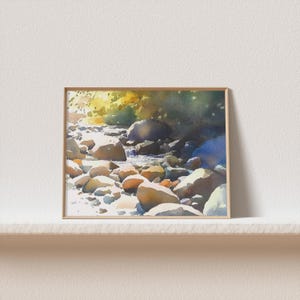 May include: Watercolor painting of a stream flowing through a rocky landscape. The stream is surrounded by smooth, rounded stones of various sizes. The water is clear and sparkling, and the sunlight is shining through the trees.