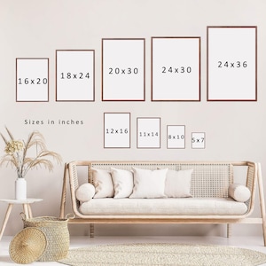 May include: A white wall with a variety of framed prints in different sizes. The frames are all brown wood and the prints are all white. The text on the prints reads "16x20", "18x24", "20x30", "24x30", "24x36", "12x16", "11x14", "8x10", and "5x7". The text "Sizes in inches" is also visible below the larger prints.