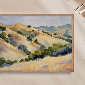 May include: Watercolor painting of a landscape with rolling hills and green trees. The hills are painted in shades of yellow, brown, and green, and the trees are a deep green. The sky is a light blue.