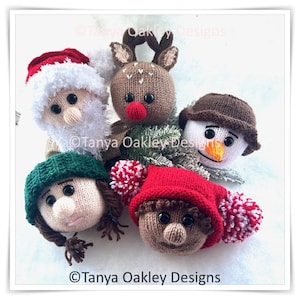 May include: A group of knitted Christmas decorations, including Santa Claus, a reindeer, a snowman, and two elf-like figures. Each ornament features a distinct design and colour palette. The text "Tanya Oakley Designs" is visible on the image.