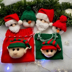 May include: Five knitted Christmas decorations, including a snowman, Santa Claus, and three elves, are displayed on red and green knitted gift bags. The decorations are all handmade and feature detailed facial features.