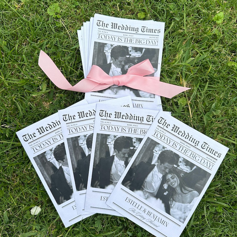May include: A stack of wedding programs printed to look like a newspaper with the headline "The Wedding Times" and the text "TODAY IS THE BIG DAY!"  The programs feature a black and white photo of the couple and the text "ESTELLE & BENJAMIN The Wedding Times".