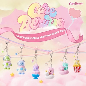 Op de afbeelding: Een verzameling Care Bears Series Keychain Blind Box-speelgoed. Elke sleutelhanger heeft een ander Care Bear-personage in een uniek ontwerp, met een zilveren ketting en sluiting. De achtergrond bevat het Care Bears-logo en tekst.