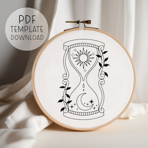 May include: Black and white line art embroidery pattern of an hourglass with a sun and moon inside, surrounded by vines.  The pattern is on a white background.